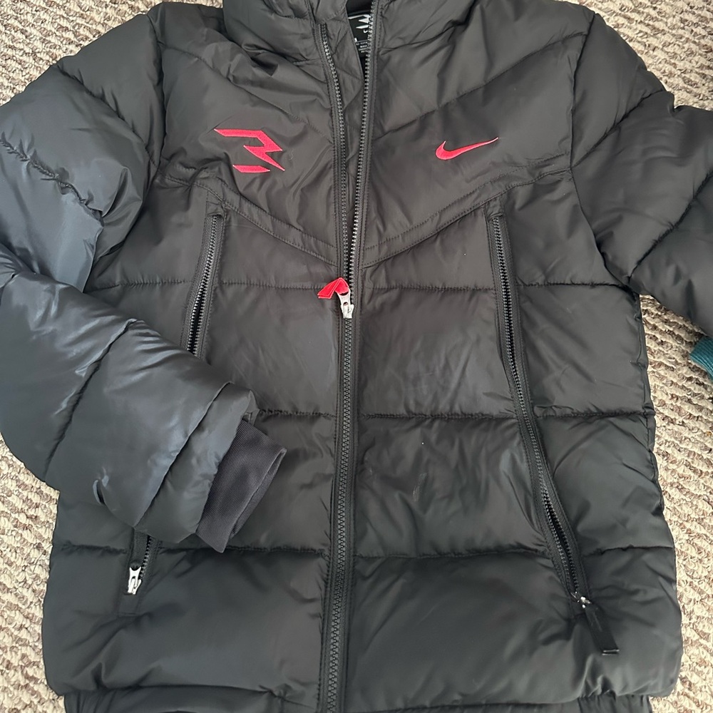 Nike black/red winter coat size youth large. Never worn.